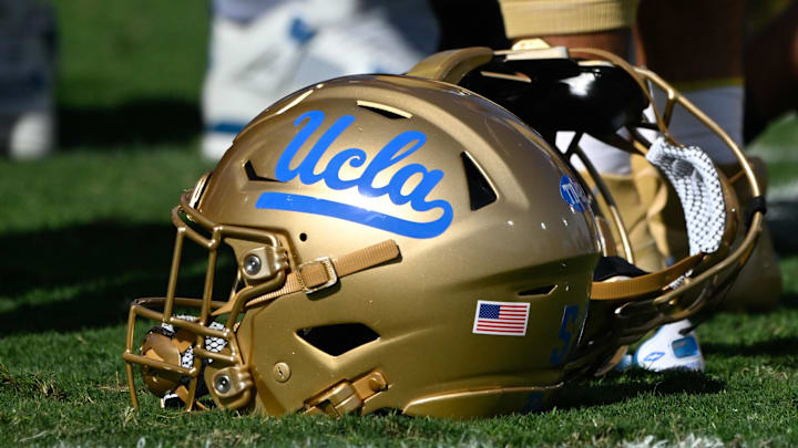 Nov 30, 2024; Pasadena, California, USA; UCLA Bruins helmets during pregame warmups before playing the Fresno State Bulldogs at Rose Bowl. Mandatory Credit: Robert Hanashiro-Imagn Images