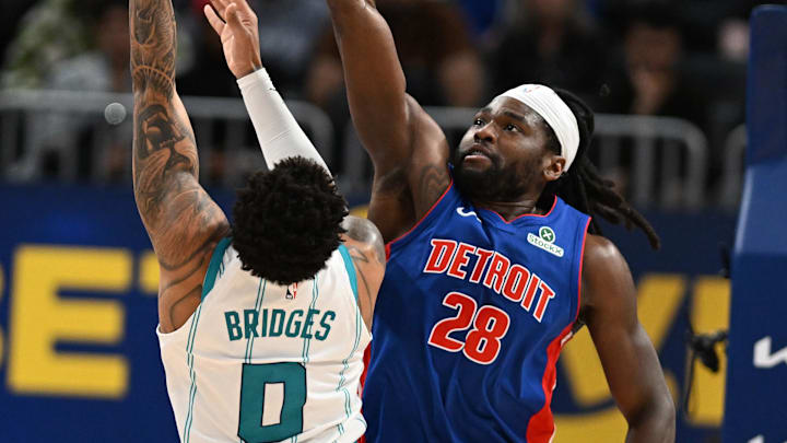Feb 9, 2025; Detroit, Michigan, USA; Charlotte Hornets forward Miles Bridges (0) shoots the ball over Detroit Pistons center Isaiah Stewart (28) in the second quarter at Little Caesars Arena. Mandatory Credit: Lon Horwedel-Imagn Images