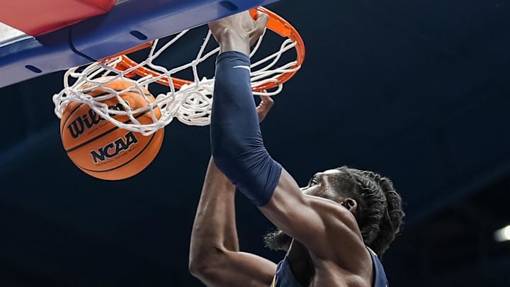 Dec 31, 2024; Lawrence, Kansas, USA; West Virginia Mountaineers center Eduardo Andre (0) dunks the ball during the first half against the Kansas Jayhawks at Allen Fieldhouse. Mandatory Credit: Jay Biggerstaff-Imagn Images