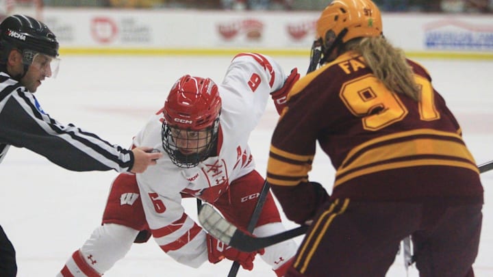 Wisconsin's Lacey Eden (6) prepares for a faceoff with Minnesota's Bella Fanale during a women's hockey game Oct. 31, 2025 at La Bahn Arena in Madison, Wisconsin.