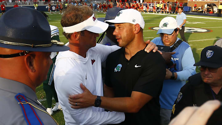 Sep 20, 2025; Oxford, Mississippi, USA; Mississippi Rebels head coach Lane Kiffin (left) and Tulane Green Wave head coach Jon Sumrall (right) embrace after the game at Vaught-Hemingway Stadium. Mandatory Credit: Petre Thomas-Imagn Images