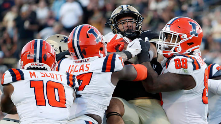 Purdue Boilermakers running back Devin Mockobee (45) is tackled by a group of Illinois Fighting Illini players during the NCAA football game, Saturday, Sept. 30, 2023, at Ross-Ade Stadium in West Lafayette, Ind. Purdue Boilermakers won 44-19.