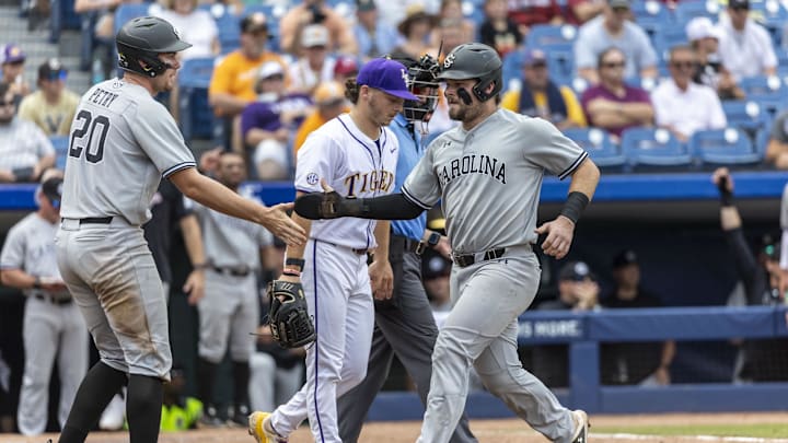 May 25, 2024; Hoover, AL, USA; South Carolina Gamecocks utility Ethan Petry (20) greets catcher Cole Messina (19) after both scored on a single by infielder Parker Noland (11) during the SEC Baseball Tournament at Hoover Metropolitan Stadium. Mandatory Credit: Vasha Hunt-Imagn Images