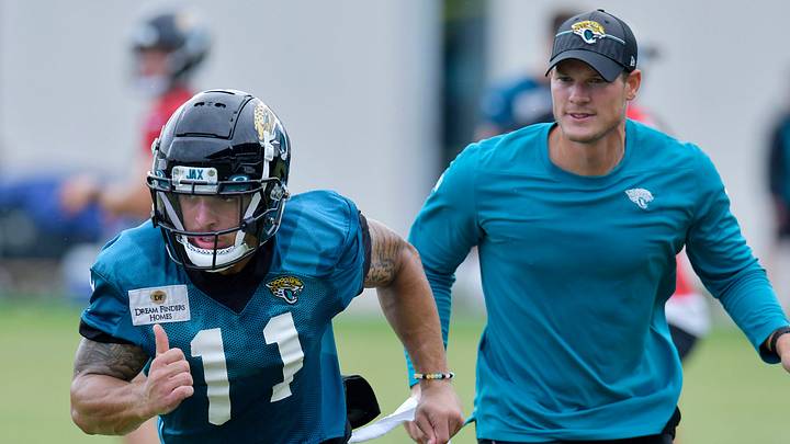 F/A-18 Super Hornet looks on as Jacksonville Jaguars wide receiver Parker Washington (11) runs a route during passing drills at the Jacksonville Jaguars Friday morning training camp session July 28, 2023 inside the Miller Electric Center training facility.