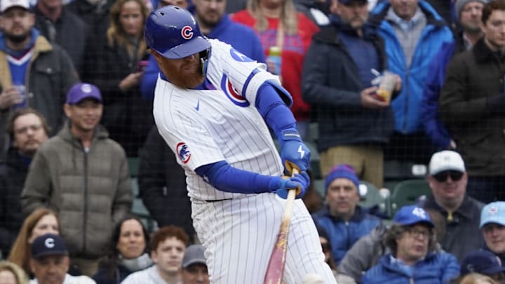 Apr 4, 2025; Chicago, Illinois, USA; Chicago Cubs pinch-hitter Justin Turner (3) hits a one-run single against the San Diego Padres during the fifth inning at Wrigley Field. 