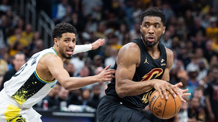 May 11, 2025; Indianapolis, Indiana, USA; Cleveland Cavaliers guard Donovan Mitchell (45) dribbles the ball while Indiana Pacers guard Tyrese Haliburton (0) defends during game four of the second round for the 2025 NBA Playoffs at Gainbridge Fieldhouse. Mandatory Credit: Trevor Ruszkowski-Imagn Images