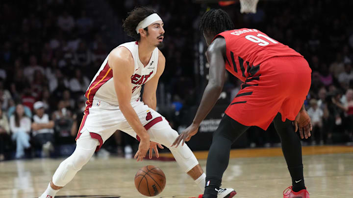Nov 8, 2025; Miami, Florida, USA;  Miami Heat forward Jaime Jaquez Jr. (11) brings the ball up the court as Portland Trail Blazers guard Sidy Cissoko (91) defends in the first quarter at Kaseya Center. Mandatory Credit: Jim Rassol-Imagn Images