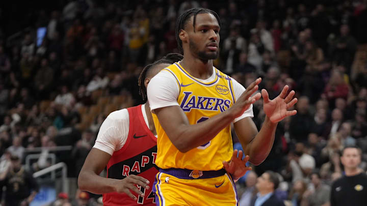 Los Angeles Lakers guard Bronny James looks for a pass while guarded by Toronto Raptors guard Ja'Kobe Walter.