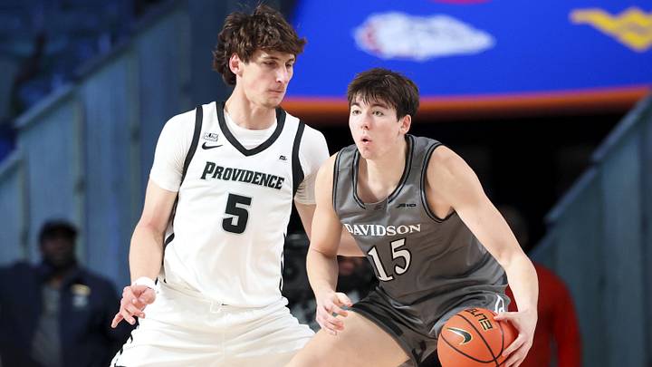 Nov 28, 2024;  Paradise Island, Bahamas, BHS; Davidson Wildcats forward Sean Logan (15) dribbles as Providence Friars center Anton Bonke (5) defends during the first half at the Imperial Arena at the Atlantis Resort.  Mandatory Credit: Kevin Jairaj-Imagn Images