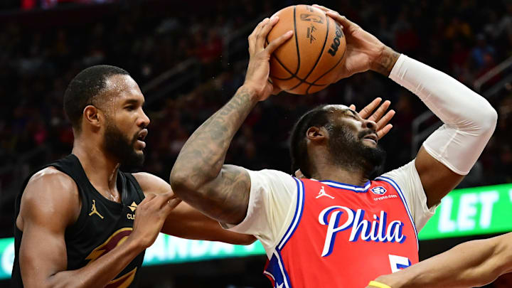 Dec 21, 2024; Cleveland, Ohio, USA; Philadelphia 76ers center Andre Drummond (5) goes for a rebound against Cleveland Cavaliers forward Evan Mobley (4) during the second half at Rocket Mortgage FieldHouse. Mandatory Credit: Ken Blaze-Imagn Images