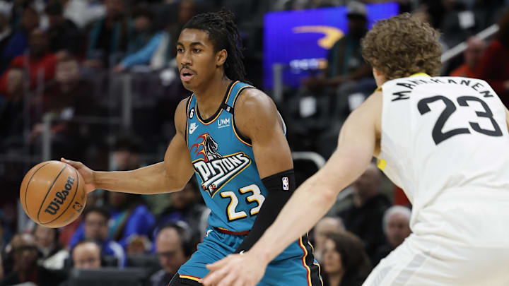 Dec 20, 2022; Detroit, Michigan, USA;  Detroit Pistons guard Jaden Ivey (23) dribbles defended by Utah Jazz forward Lauri Markkanen (23) in the first half at Little Caesars Arena. Mandatory Credit: Rick Osentoski-Imagn Images