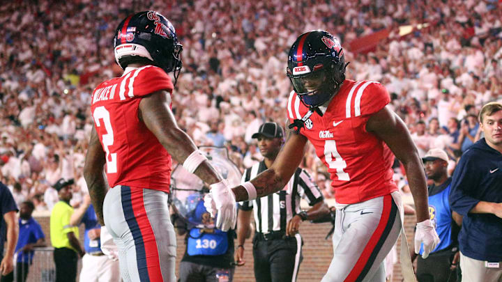 Aug 30, 2025; Oxford, Mississippi, USA; Mississippi Rebels tight end Caleb Odom (4) reacts with wide receiver Harrison Wallace III (2) after a touchdown during the third quarter  against the Georgia State Panthers at Vaught-Hemingway Stadium. Mandatory Credit: Petre Thomas-Imagn Images