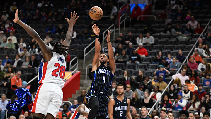 Orlando Magic guard Jalen Suggs (4) shoots the ball over Detroit Pistons center Isaiah Stewart (28) at the end of the second second quarter at Little Caesars Arena.