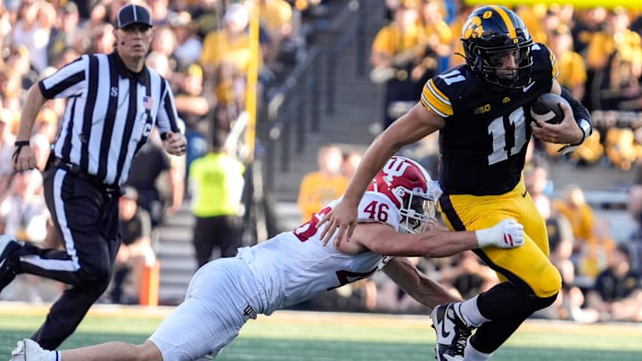 Iowa Hawkeyes quarterback Mark Gronowski (11) is tackled by Indiana Hoosiers linebacker Isaiah Jones (46) Sept. 27, 2025 at Kinnick Stadium in Iowa City, Iowa.