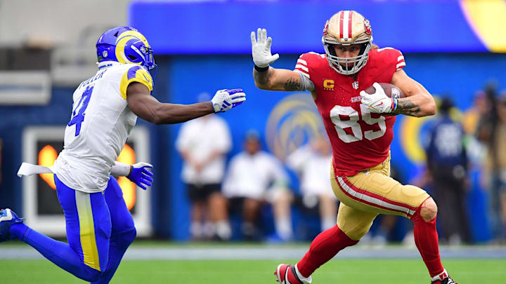 Sep 17, 2023; Inglewood, California, USA; San Francisco 49ers tight end George Kittle (85) runs the ball against Los Angeles Rams safety Jordan Fuller (4) during the second half at SoFi Stadium. Mandatory Credit: Gary A. Vasquez-Imagn Images