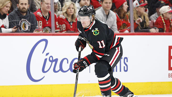 Jan 23, 2026; Chicago, Illinois, USA; Chicago Blackhawks center Oliver Moore (11) controls the puck against the Tampa Bay Lightning during the first period at United Center. Mandatory Credit: Kamil Krzaczynski-Imagn Images