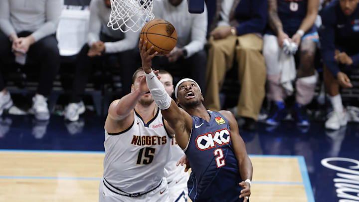 Feb 27, 2026; Oklahoma City, Oklahoma, USA; Oklahoma City Thunder guard Shai Gilgeous-Alexander (2) goes up for a basket in front of Denver Nuggets center Nikola Jokić (15) during the fourth quarter at Paycom Center. Mandatory Credit: Alonzo Adams-Imagn Images