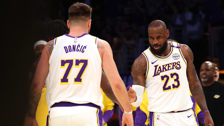 Mar 2, 2025; Los Angeles, California, USA; Los Angeles Lakers forward LeBron James (23) and guard Luka Doncic (77) react after a play during the first quarter against the LA Clippers at Crypto.com Arena. Mandatory Credit: Jason Parkhurst-Imagn Images