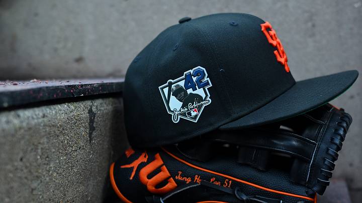 Apr 15, 2026; Cincinnati, Ohio, USA;  A view of a Giants game hat on the dugout steps, with a patch honoring Jackie Robinson during the game between the San Francisco Giants and the Cincinnati Reds at Great American Ball Park. Players and coaches will wear No. 42 in honor of Jackie Robinson Day around the league. Mandatory Credit: Aaron Doster-Imagn Images