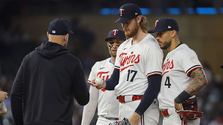 Sep 24, 2024; Minneapolis, Minnesota, USA; Minnesota Twins starting pitcher Bailey Ober (17) gives the ball to manager Rocco Baldelli after pitching to the Miami Marlins as third baseman Royce Lewis (23) and Carlos Correa (4) look on in the sixth inning at Target Field. Mandatory Credit: Bruce Kluckhohn-Imagn Images