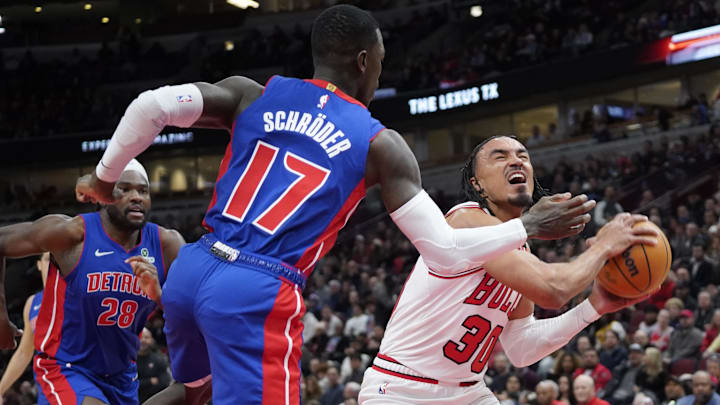Feb 11, 2025; Chicago, Illinois, USA; Detroit Pistons Dennis Schroder (17) defends Chicago Bulls guard Tre Jones (30) during the first quarter at United Center. Mandatory Credit: David Banks-Imagn Images