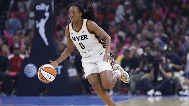 Jul 27, 2025; Chicago, Illinois, USA; Indiana Fever guard Kelsey Mitchell (0) brings the ball up court against the Chicago Sky during the first half at United Center. Mandatory Credit: Kamil Krzaczynski-Imagn Images