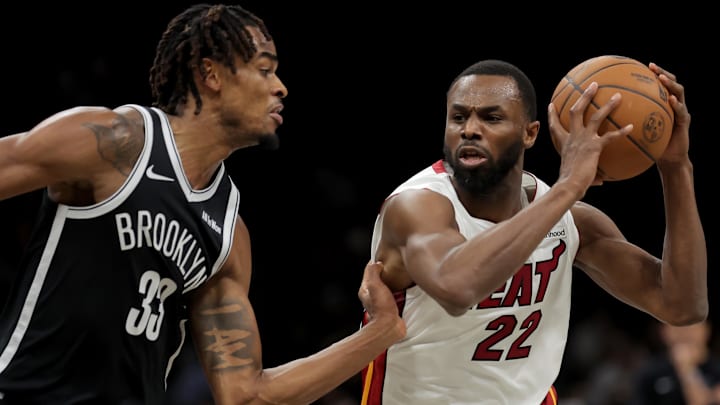 Dec 18, 2025; Brooklyn, New York, USA; Miami Heat forward Andrew Wiggins (22) drives to the basket against Brooklyn Nets center Nic Claxton (33) during the third quarter at Barclays Center. Mandatory Credit: Brad Penner-Imagn Images