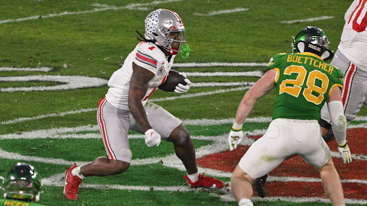 Jan 1, 2025; Pasadena, CA, USA; Ohio State Buckeyes running back Quinshon Judkins carries the ball as Oregon Ducks linebacker Bryce Boettcher (28) moves in to make the tackle during the fourth quarter at Rose Bowl Stadium. 