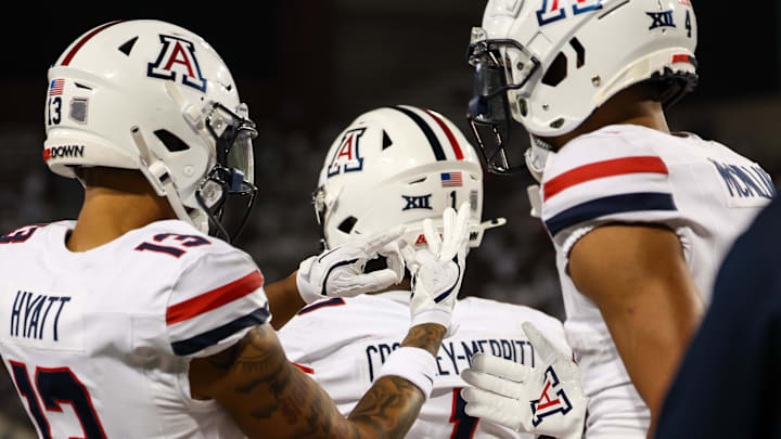 Aug 31, 2024; Tucson, Arizona, USA; Arizona Wildcats wide receiver Devin Hyatt (13) counts on his hand how many touchdowns Arizona Wildcats wide receiver Tetairoa McMillan (4) has made during third quarter at Arizona Stadium.