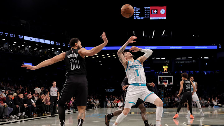 Nov 19, 2024; Brooklyn, New York, USA; Charlotte Hornets guard LaMelo Ball (1) loses  the ball after being fouled by Brooklyn Nets guard Ben Simmons (10) during the first quarter at Barclays Center. Mandatory Credit: Brad Penner-Imagn Images