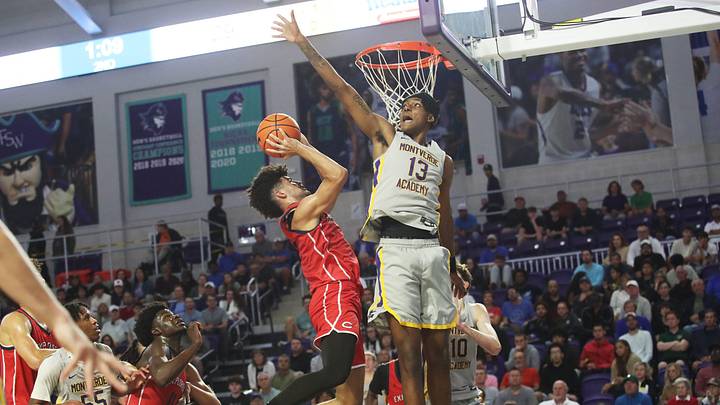 Cayden Boozer of the Miami Columbus High School basketball team drives to the basket during the championship game against Montverde at the City of Palms Classic at Suncoast Credit Union Arena in Fort Myers on Monday, Dec. 23, 2024. He is defended by Hakeem Weems of Montverde Acdademy. Miami Columbus won.