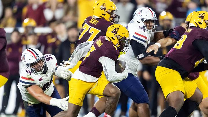 Nov 28, 2025; Tempe, Arizona, USA; Arizona State Sun Devils running back Raleek Brown (3) runs the ball against Arizona Wildcats defensive lineman Mays Pese (99) in the first half during the 99th Territorial Cup at Mountain America Stadium. Mandatory Credit: Mark J. Rebilas-Imagn Images Nov 28, 2025; Tempe, Arizona, USA; Arizona State Sun Devils running back Raleek Brown (3) runs the ball against Arizona Wildcats defensive lineman Mays Pese (99) in the first half during the 99th Territorial Cup at Mountain America Stadium. Mandatory Credit: Mark J. Rebilas-Imagn Images