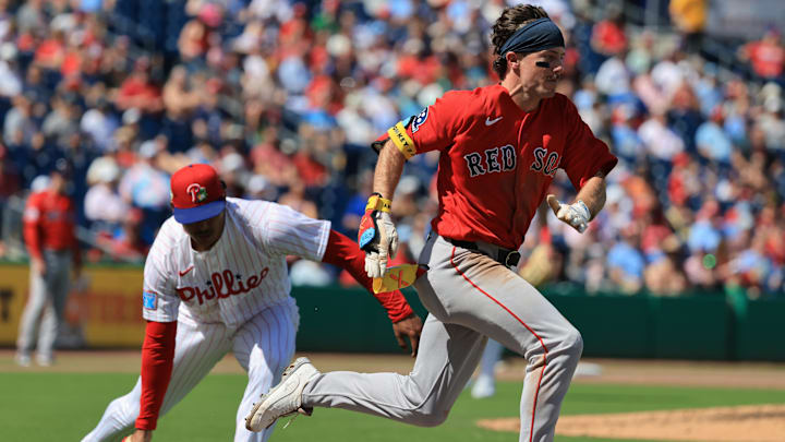 Mar 5, 2026; Clearwater, Florida, USA;  Boston Red Sox outfielder Braiden Ward (92) bunts for a single against the Philadelphia Phillies at BayCare Ballpark. Mandatory Credit: Kim Klement Neitzel-Imagn Images