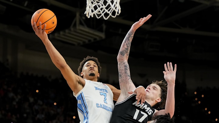 Mar 19, 2026; Greenville, SC, USA; North Carolina Tar Heels guard Seth Trimble (7) goes to the basket against VCU Rams forward Lazar Djokovic (17) in the second half of a first round game of the men's 2026 NCAA Tournament at Bon Secours Wellness Arena. Mandatory Credit: Bob Donnan-Imagn Images