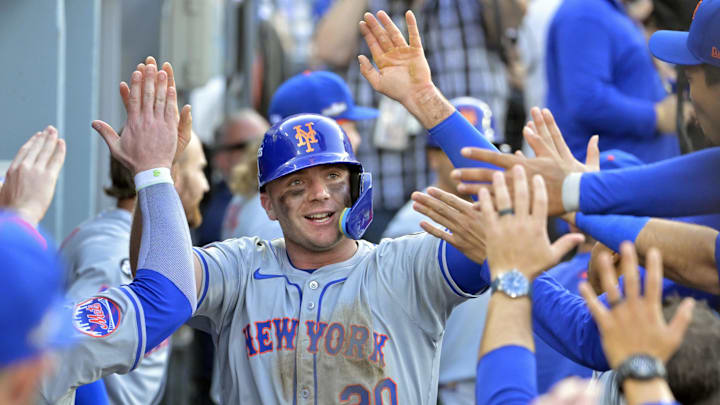 Oct 14, 2024; Los Angeles, California, USA; New York Mets first baseman Pete Alonso (20) celebrates in the dugout after scoring in the ninth inning against the Los Angeles Dodgers during game two of the NLCS for the 2024 MLB Playoffs at Dodger Stadium. Mandatory Credit: Jayne Kamin-Oncea-Imagn Images