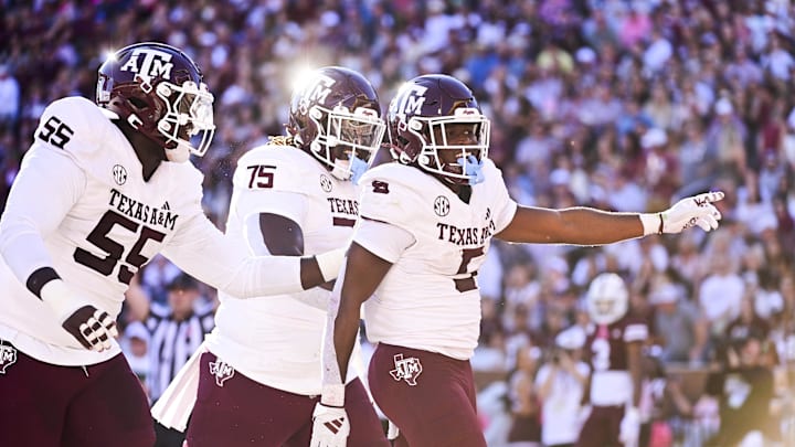 Oct 19, 2024; Starkville, Mississippi, USA;Texas A&M Aggies running back Amari Daniels (5) celebrates with teammates after a touchdown against the Mississippi State Bulldogs during the second quarter at Davis Wade Stadium at Scott Field. Mandatory Credit: Matt Bush-Imagn Images