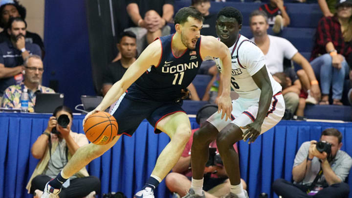 UConn forward Alex Karaban dribbles the ball past Dayton's Enoch Cheeks at the Maui Invitational.