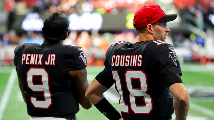 ATLANTA, GEORGIA - DECEMBER 22: Michael Penix Jr. #9 and Kirk Cousins #18 of the Atlanta Falcons look on from the sideline during the fourth quarter against the New York Giants at Mercedes-Benz Stadium on December 22, 2024 in Atlanta, Georgia. 