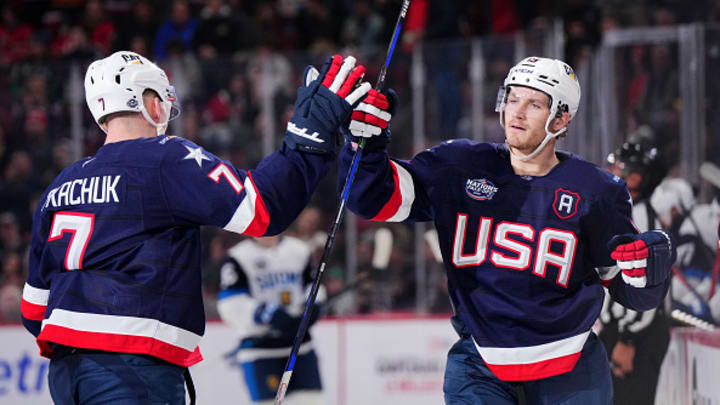 Brady Tkachuk and Matthew Tkachuk high five during 4 Nations Face-Off clash vs. Finland.