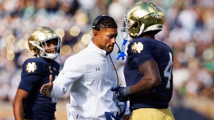 Notre Dame head coach Marcus Freeman, center, slaps hands with running back Jeremiyah Love (4) after a Love touchdown in the first half of a NCAA football game against NC State at Notre Dame Stadium on Saturday, Oct. 11, 2025, in South Bend.