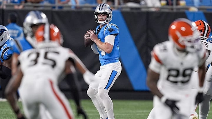 Aug 8, 2025; Charlotte, North Carolina, USA; Carolina Panthers quarterback Andy Dalton (14) drops back to pass during the second quarter against the Carolina Panthers at Bank of America Stadium.