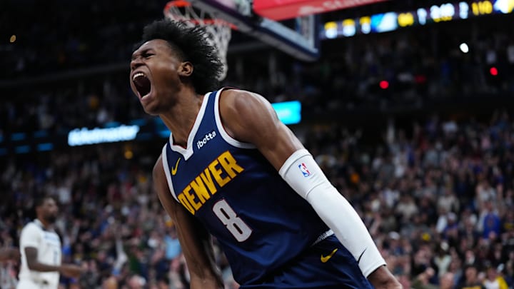 Apr 10, 2024; Denver, Colorado, USA; Denver Nuggets forward Peyton Watson (8) reacts after his dunk in the fourth quarter against the Minnesota Timberwolves at Ball Arena. Mandatory Credit: Ron Chenoy-Imagn Images