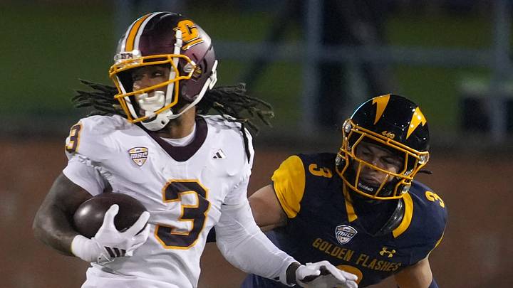 Central Michigan wide receiver Tyson Davis (3) looks to evade Kent State linebacker CJ Young (3) during the first half of the game at Dix Stadium in Kent on November, 19, 2025. Central Michigan wide receiver Tyson Davis (3) looks to evade Kent State linebacker CJ Young (3) during the first half of the game at Dix Stadium in Kent on November, 19, 2025.