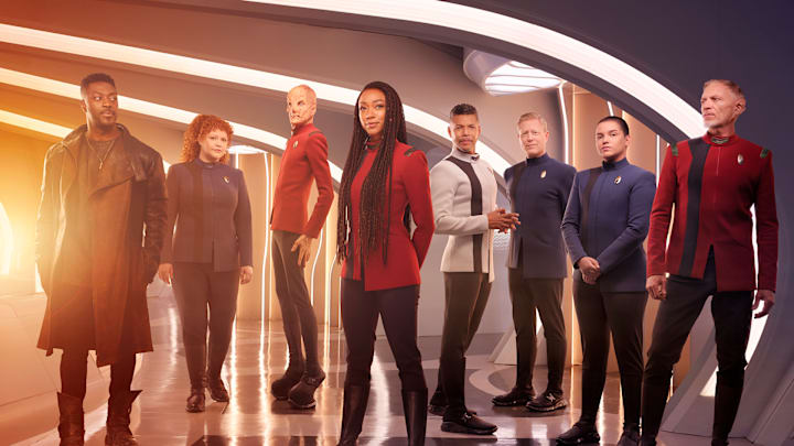 L-R David Ajala as Book, Mary Wiseman as Tilly, Doug Jones as Saru, Sonequa Martin-Green as Burnham, Wilson Cruz as Culber, Blu Del Barrio as Adira and Callum Keith Rennie as Raynor in season 5 of the Paramount+ original series STAR TREK: DISCOVERY. Photo Credit: James Dimmock/Paramount+