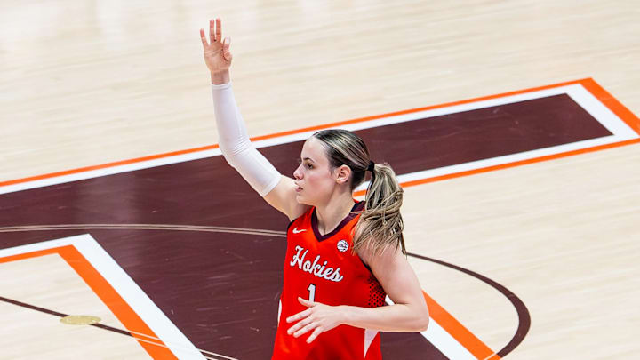 Carleigh Wenzel lifts her hand in celebration as she transitions back to defense after a three point basket. Carleigh Wenzel lifts her hand in celebration as she transitions back to defense after a three point basket.