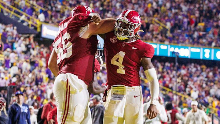 Nov 9, 2024; Baton Rouge, Louisiana, USA;  Alabama Crimson Tide quarterback Jalen Milroe (4) celebrates a touchdown with offensive lineman Geno VanDeMark (56) against the LSU Tigers during the second half at Tiger Stadium. Mandatory Credit: Stephen Lew-Imagn Images
