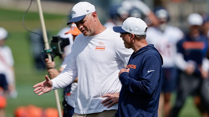 Jul 24, 2025; Englewood, CO, USA; Denver Broncos offensive coordinator Joe Lombardi (L) and offensive assistant Pete Carmichael (R) during Denver Broncos Training Camp. 