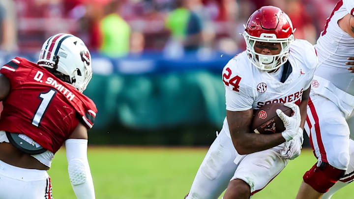 Oklahoma running back Xavier Robinson hits a hole against South Carolina. Oklahoma running back Xavier Robinson hits a hole against South Carolina.