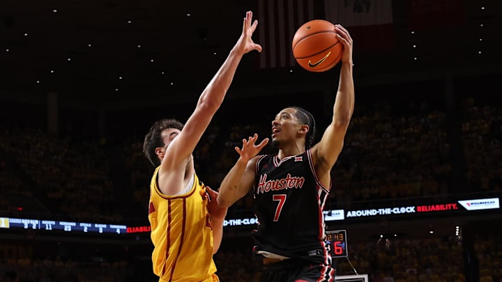 Feb 16, 2026; Ames, Iowa, USA; Iowa State Cyclones forward Milan Momcilovic (22) defends Houston Cougars guard Milos Uzan (7) during the second half at James H. Hilton Coliseum. 