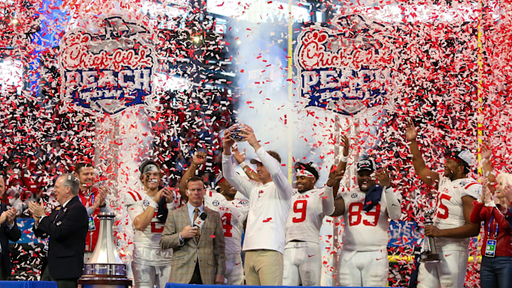 Dec 30, 2023; Atlanta, GA, USA; Mississippi Rebels head coach Lane Kiffin holds up the Peach Bowl